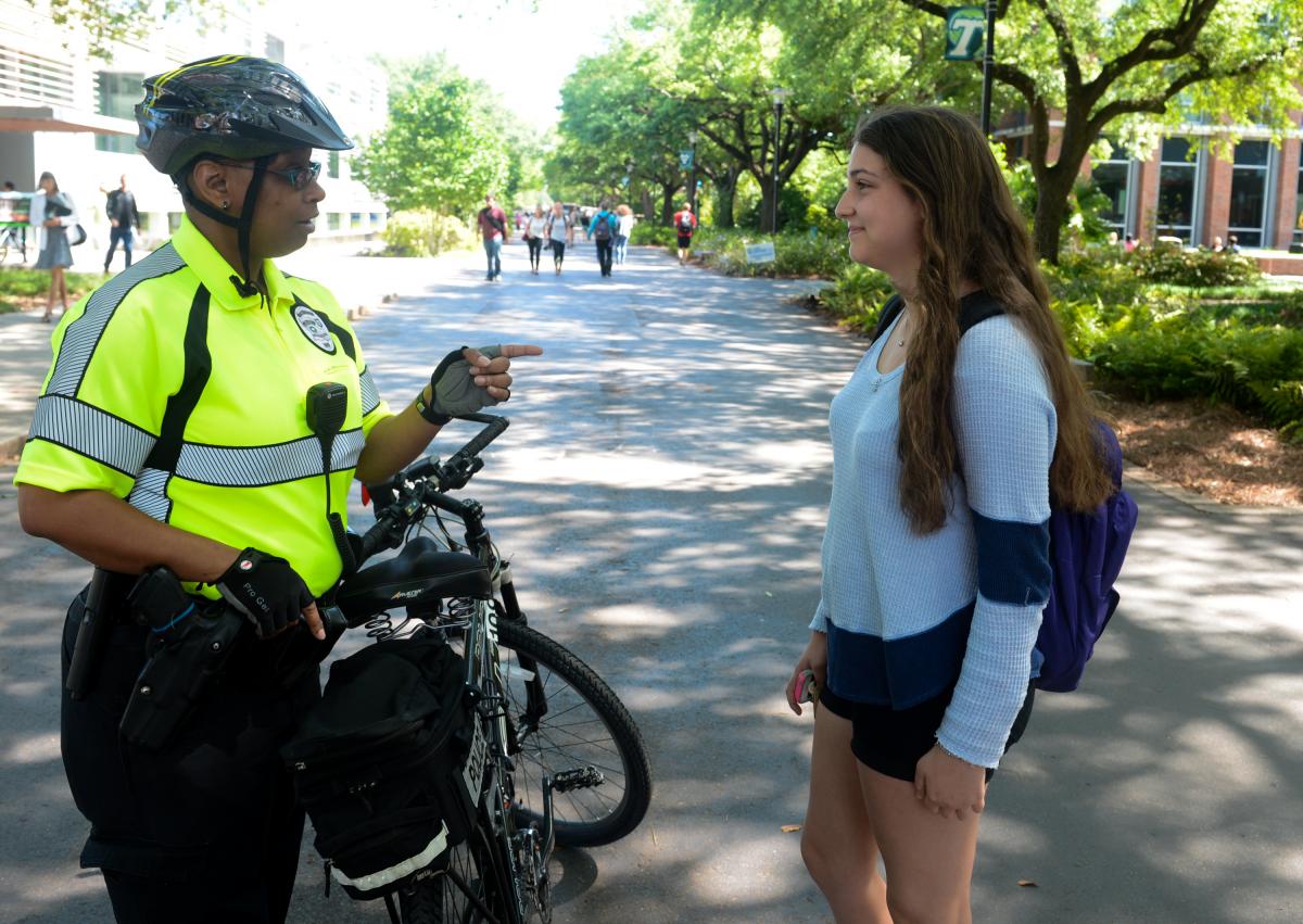 Tulane University Police Department officer talking to student